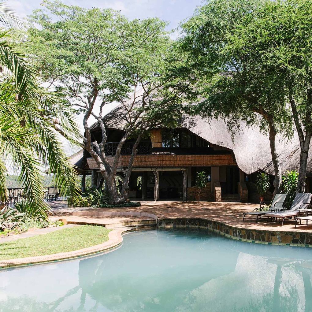 Rieten tweeverdiepingslodge met zwembad tussen de bomen bij Chilo Gorge Safari Lodge in Gonarezhou.